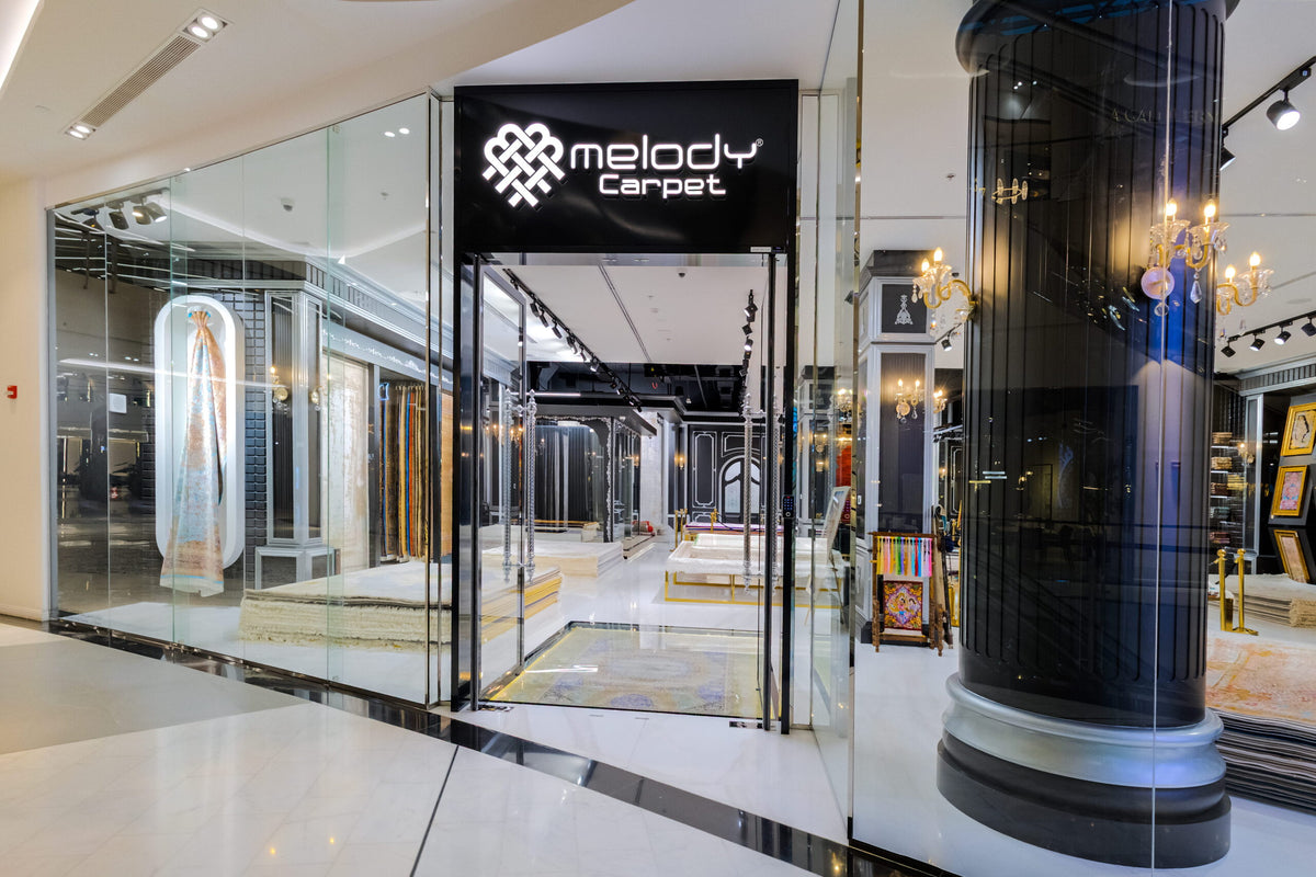 Melody Carpet Art of Living Mall showroom entrance with illuminated Melody sign.
