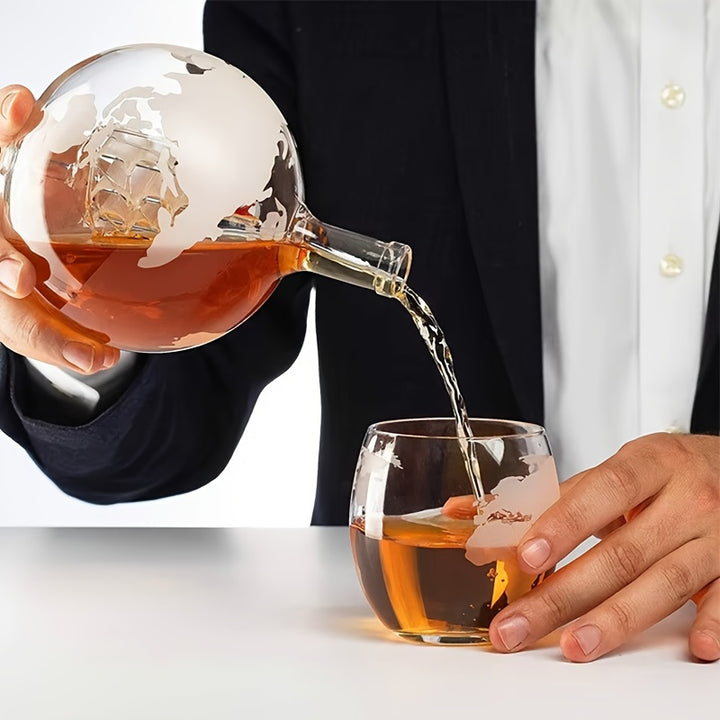 Supplier pouring demonstration of a globe decanter variant with an internal ship. This item&