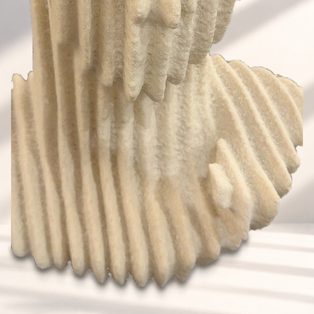 Detail of layered shoulders and integrated base against a styled studio background