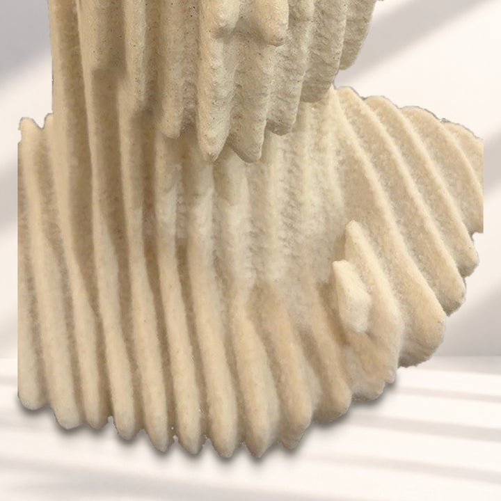 Detail of layered shoulders and integrated base against a styled studio background